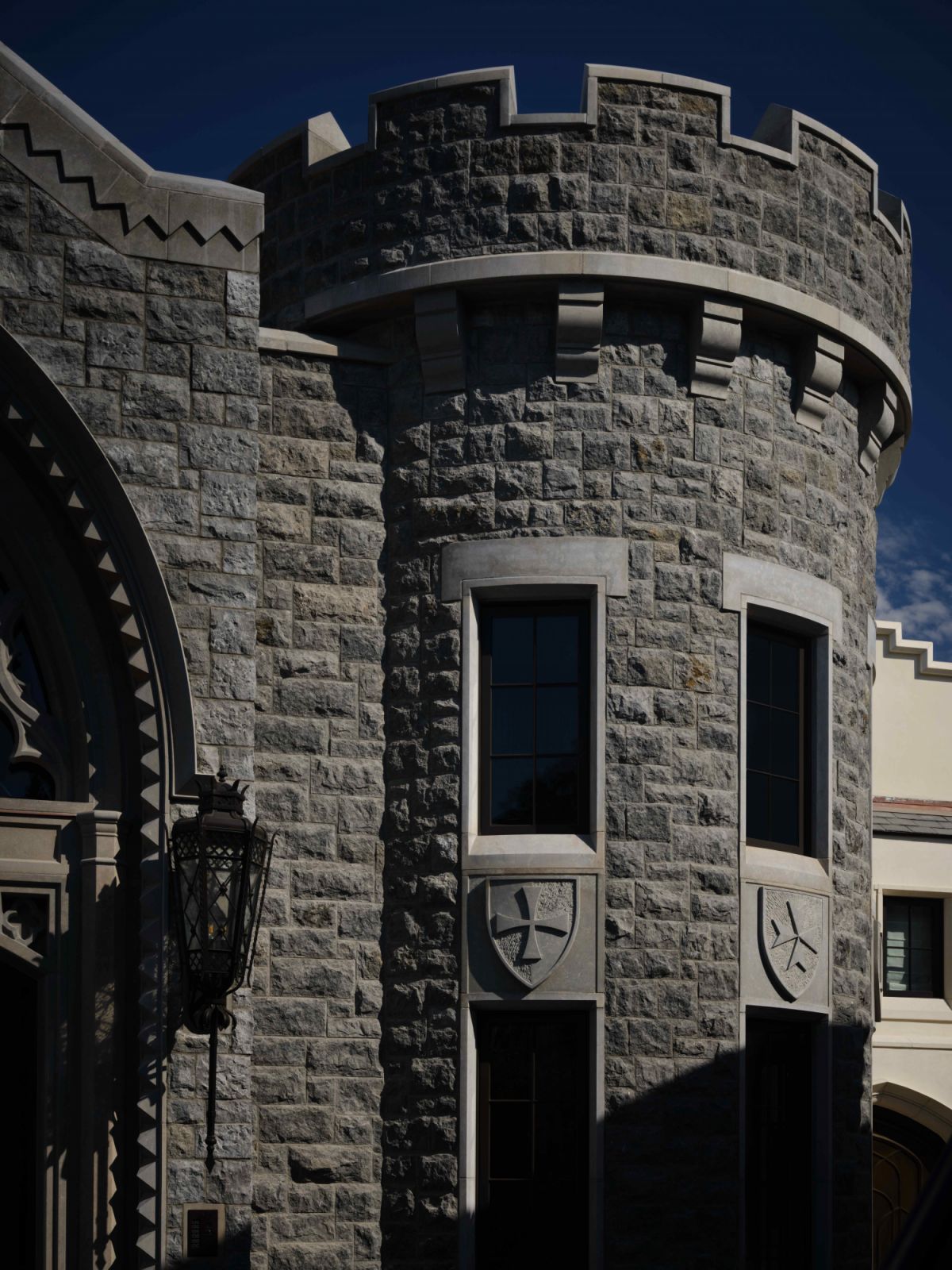 The Gothic-inspired façade features Nova Blue limestone sourced and quarried from Portugal