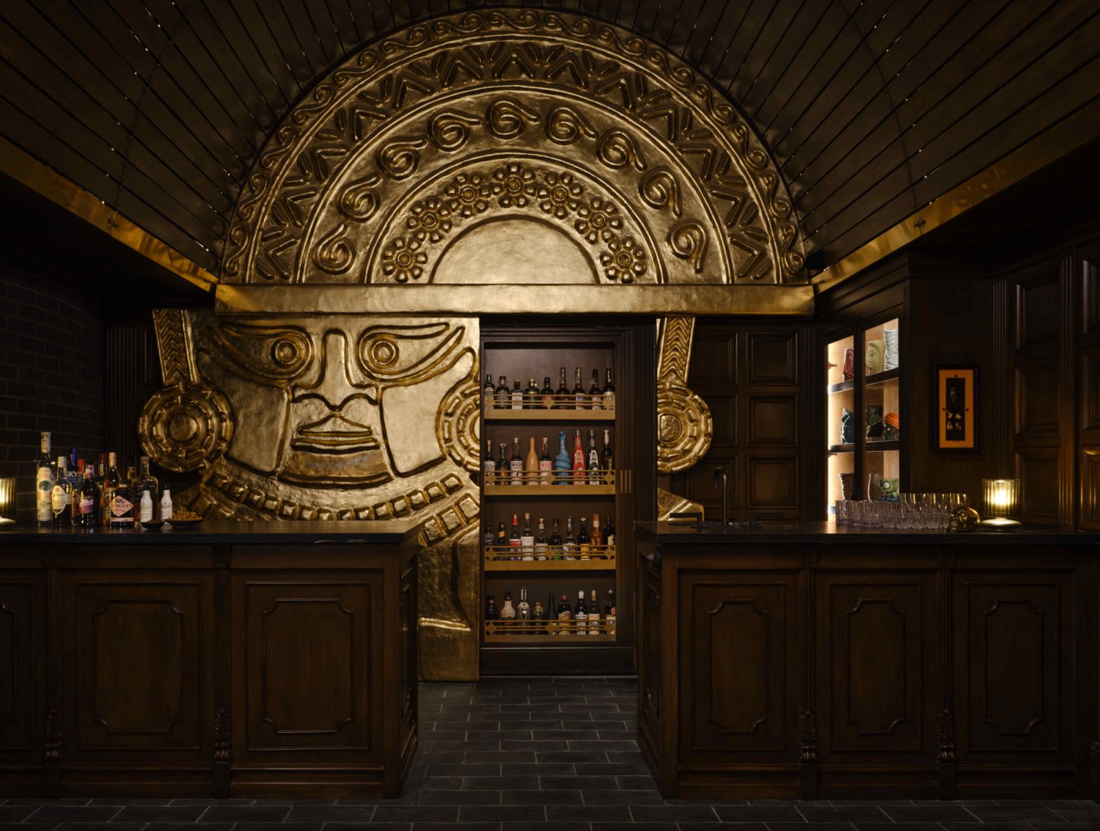 The hidden liquor rack doubles as an entrance to a private spa area