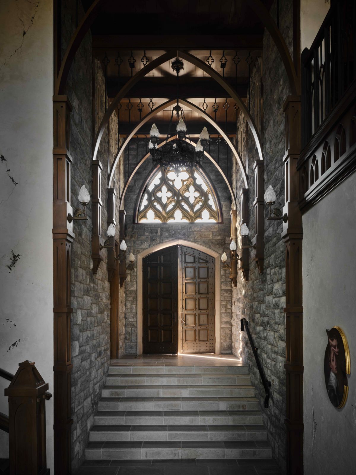Refurbished vintage doors that lead into the voluminous entry hall