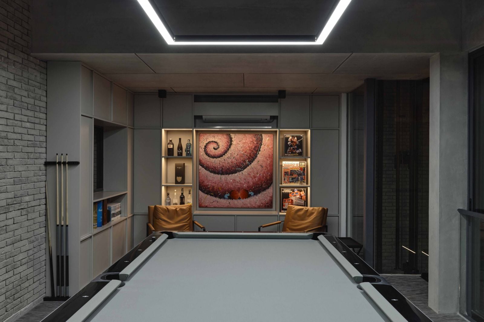 The well-appointed entertainment room, where an artwork takes centre stage, is a pleasingly symmetrical space anchored by a pool table