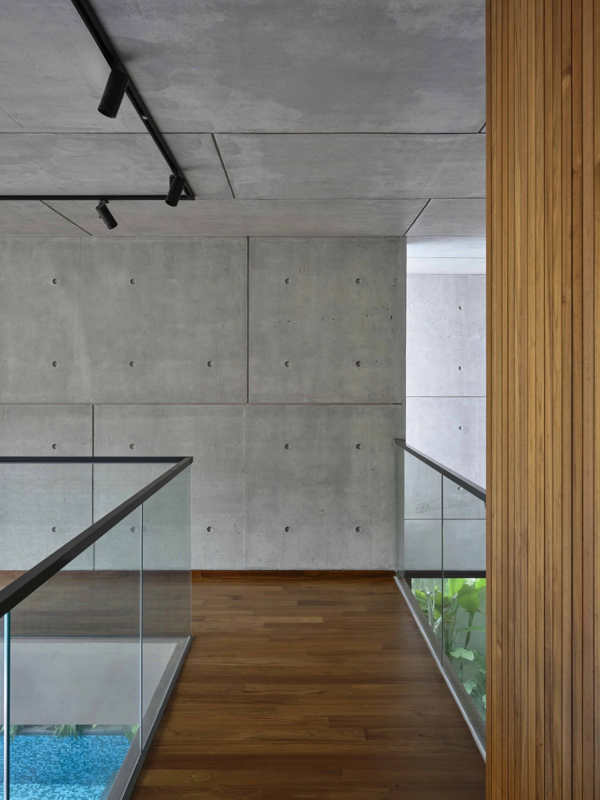 A corner that showcases the harmonious coexistence of concrete, wood, and negative space