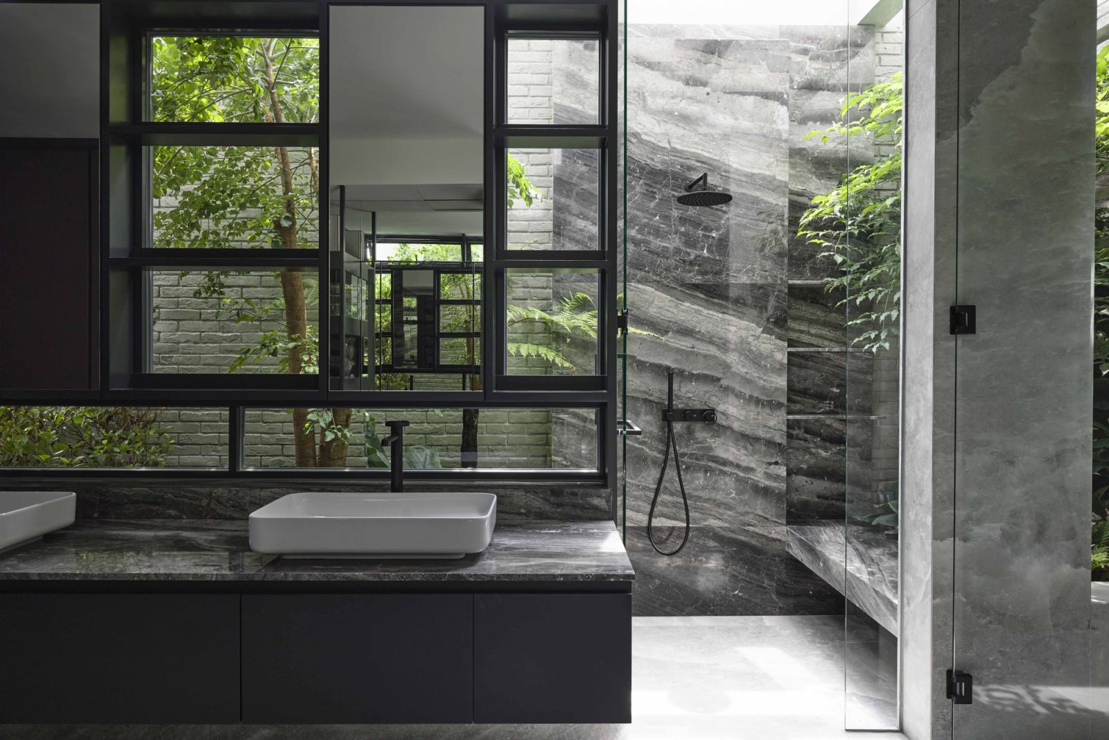 Even the master bathroom is verdant with greenery and drenched in sunlight