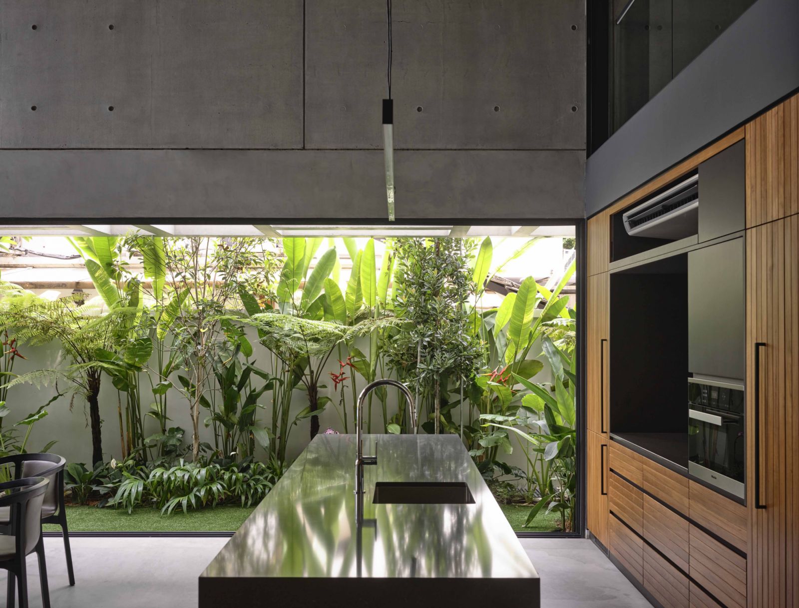 The side garden, though narrow, is replete with greenery and serves as a view from the dry kitchen