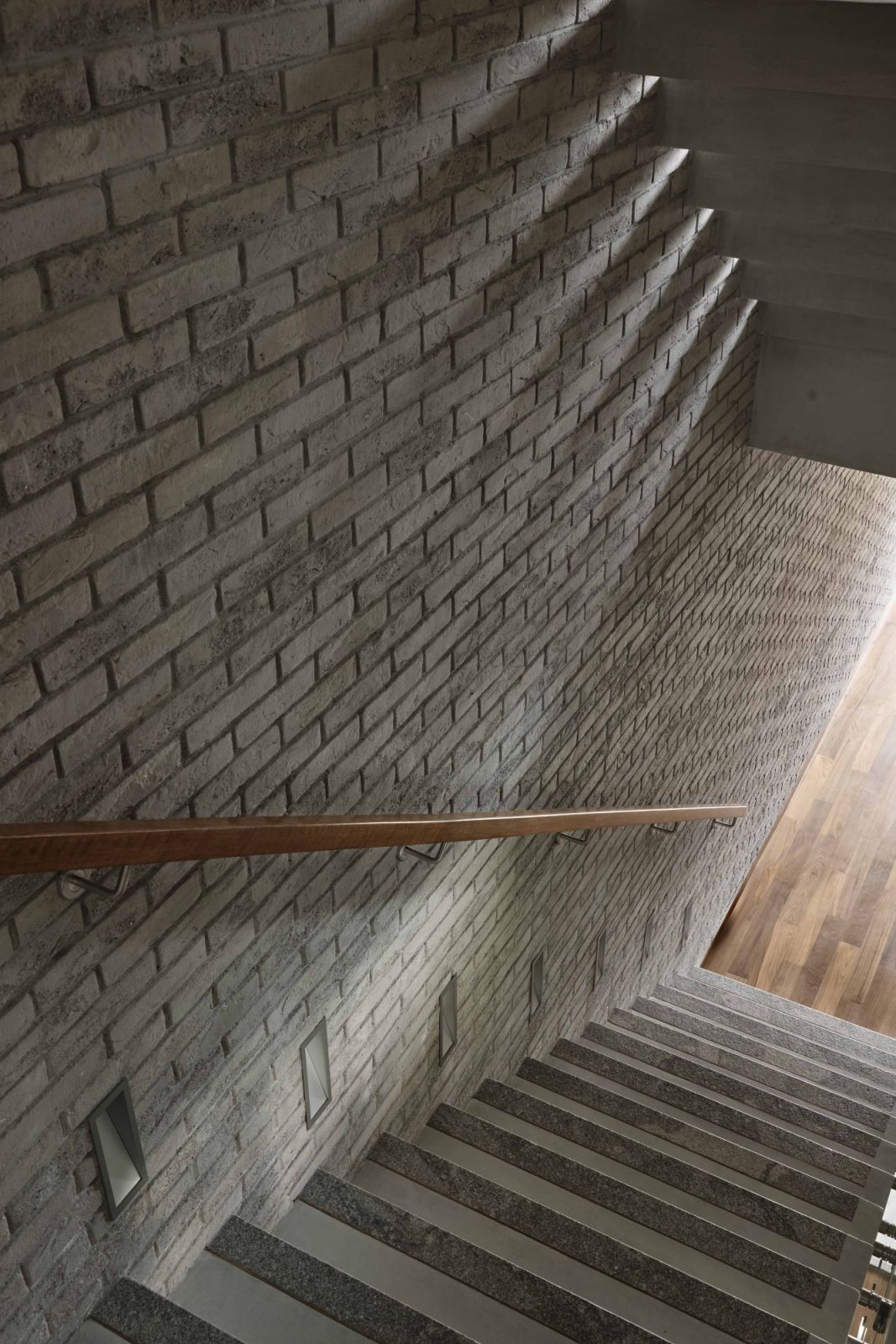 Light filters through the staircase gaps, creating a moody, atmospheric effect