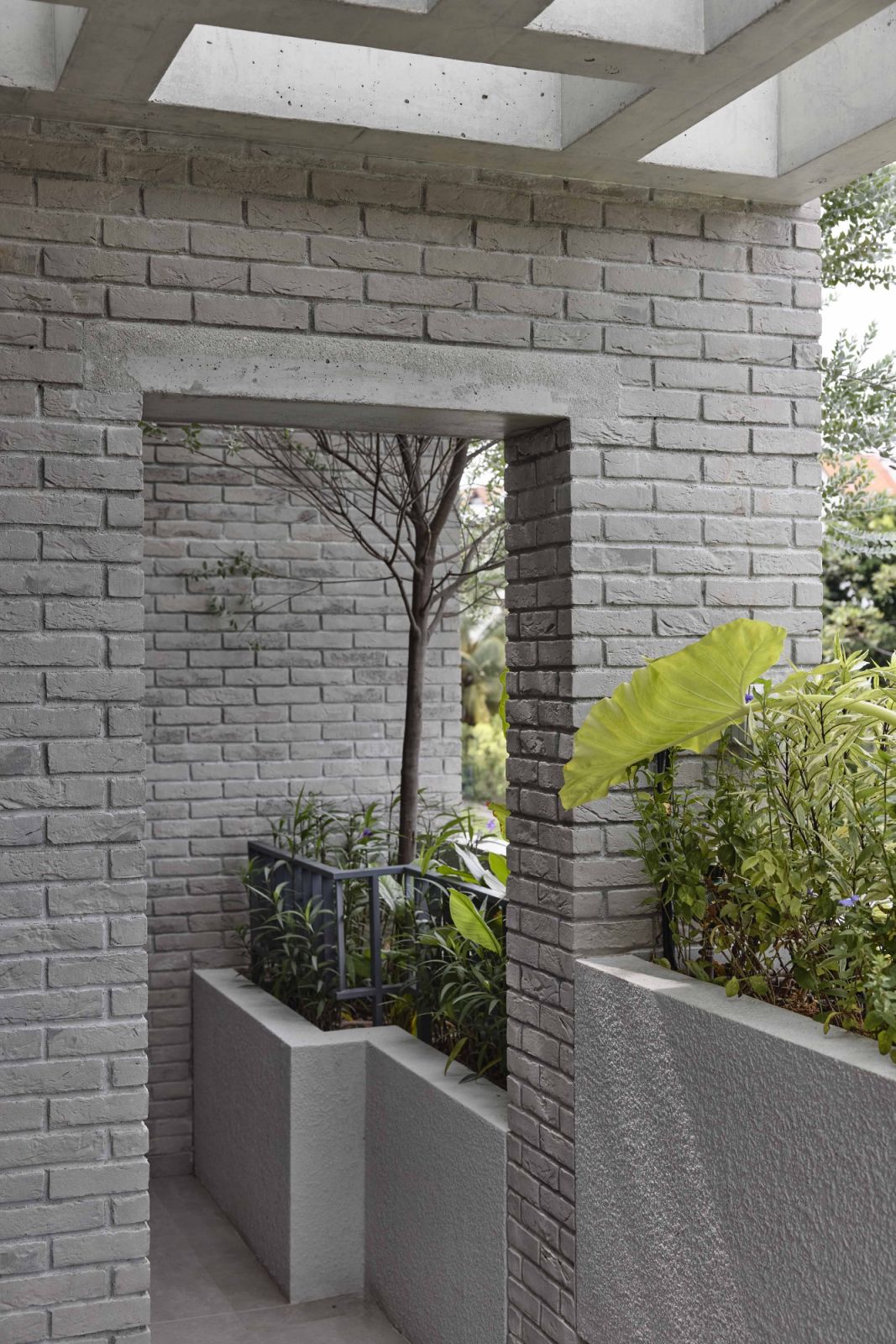 The planters bring softness to the brutalist-inspired architecture