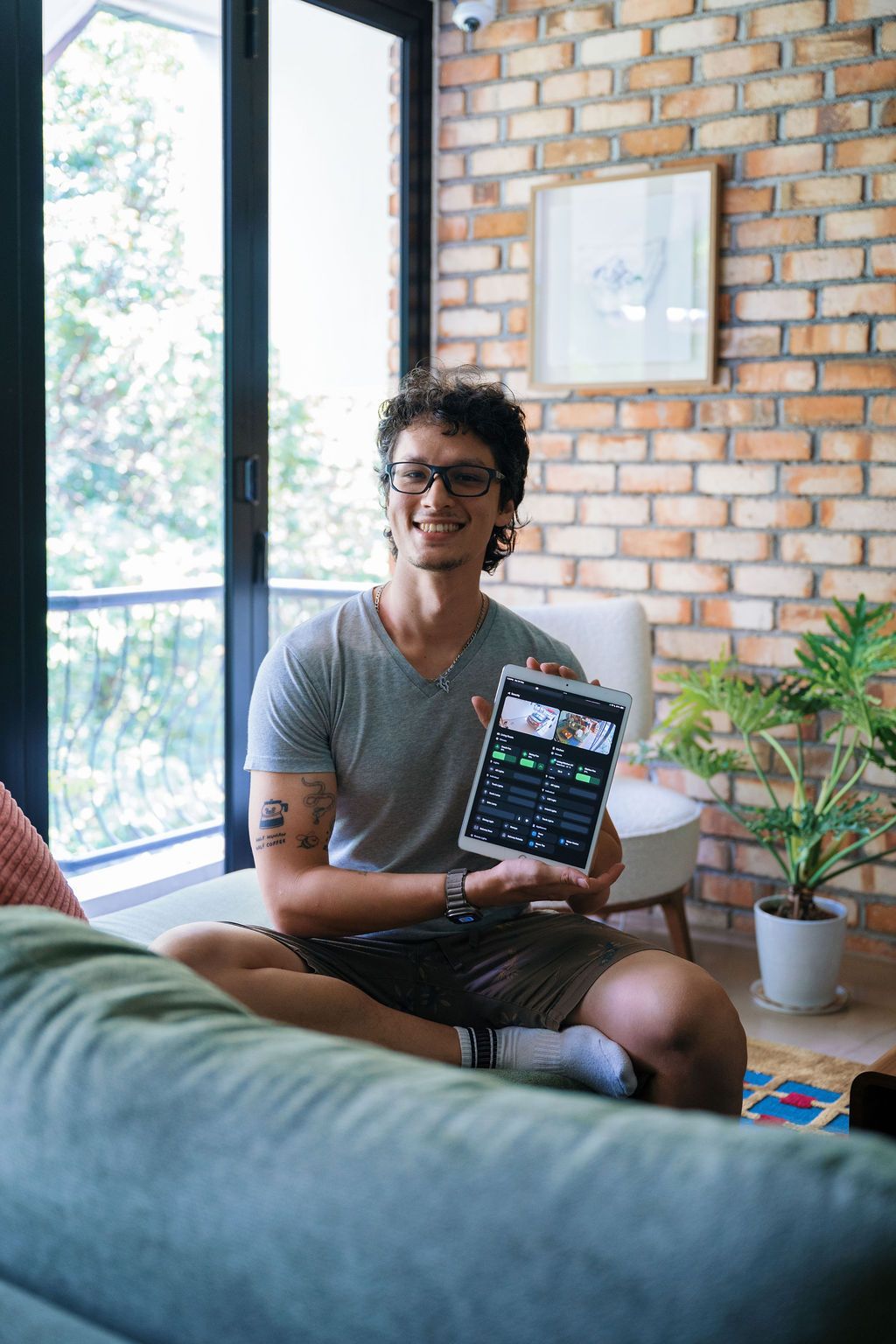 Murmann holding his one-stop control centre for his home