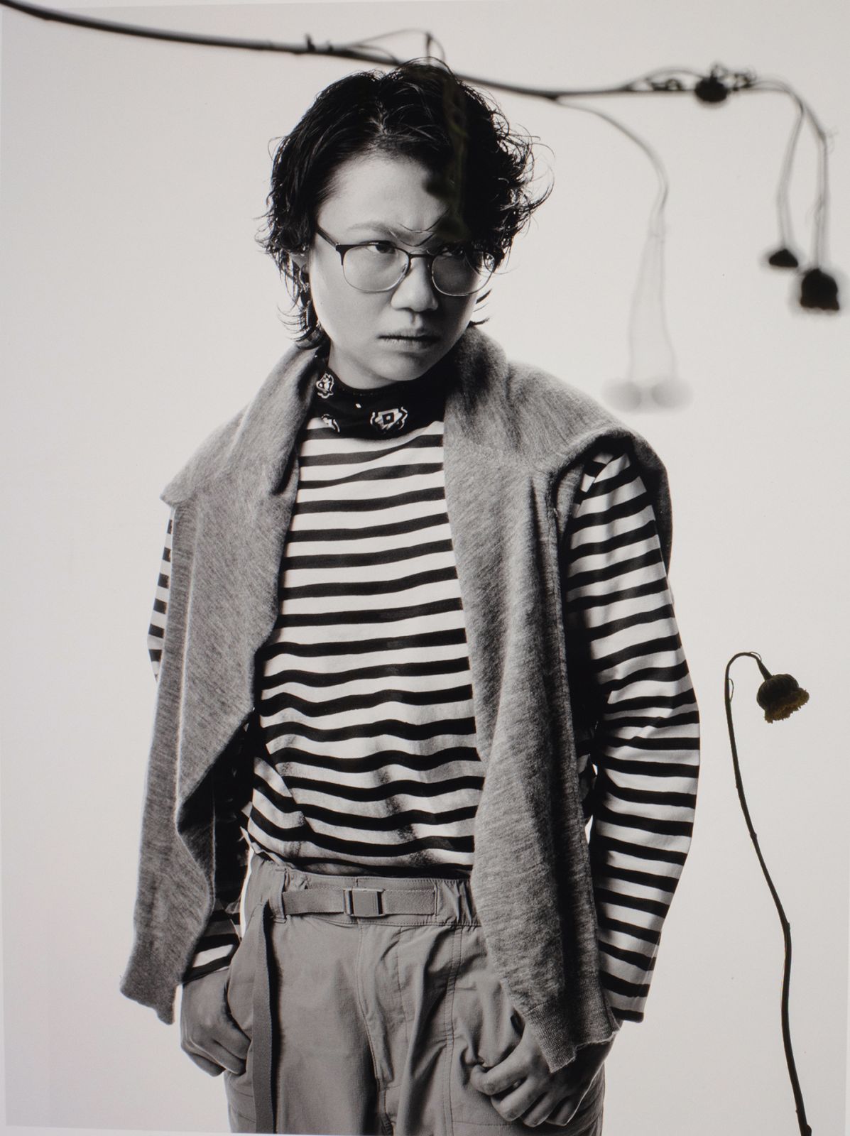 Chien wears Prada Trompe L’Oiel shirt, Loro Piana cashmere sweater and Uniqlo pants