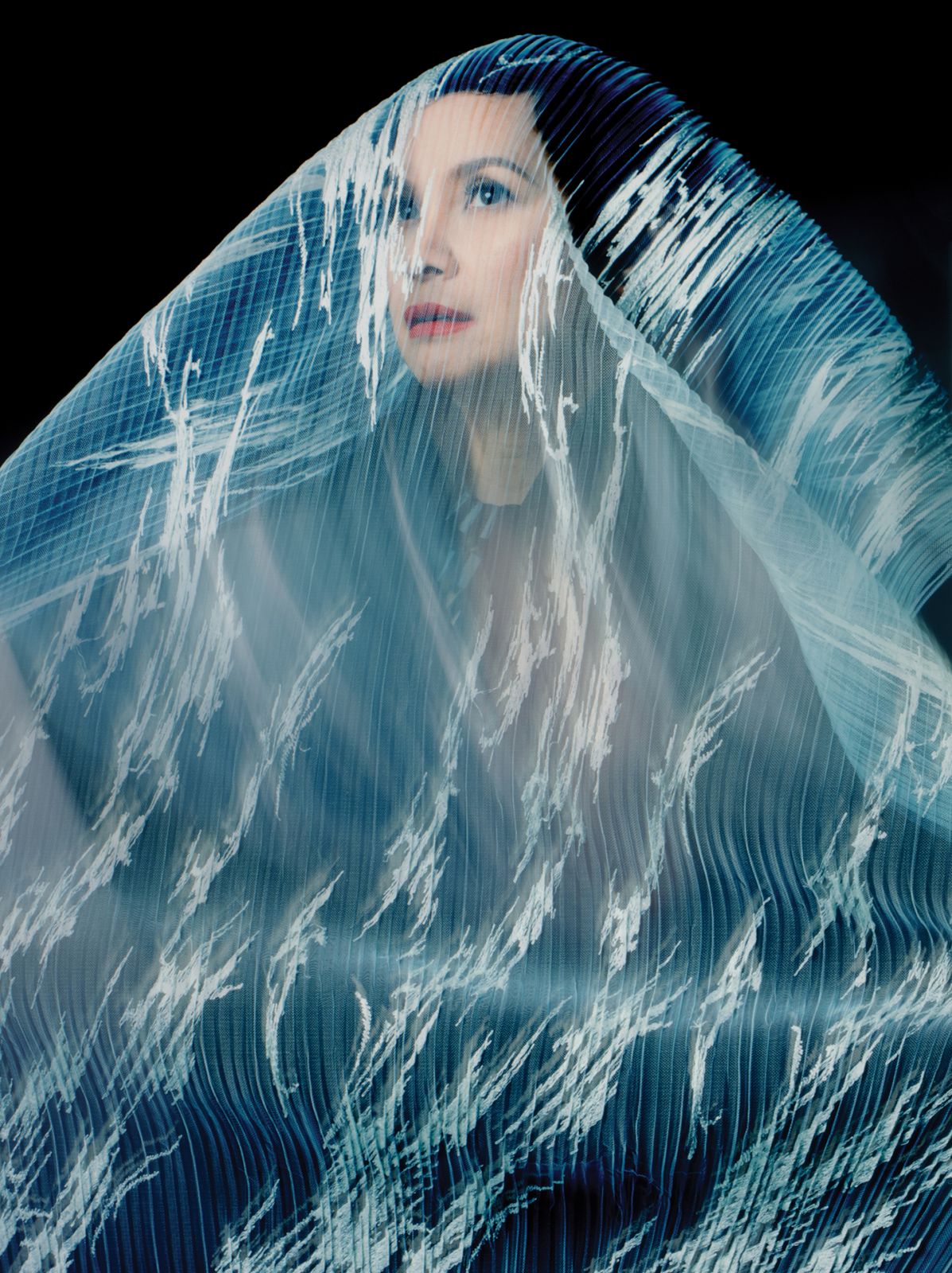 Salonga wears Valentino jacket, Brent Neale earrings, Natori necklace and Moods Fabric veil