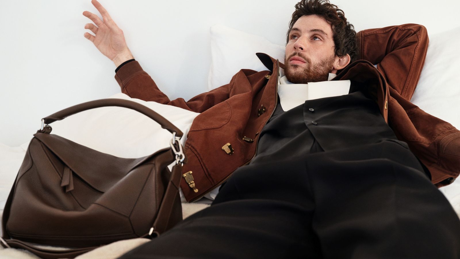 Loewe’s tailoring unravels and reassembles itself—melting shoulders, asymmetric hems modelled by ambassador Josh O’Connor
