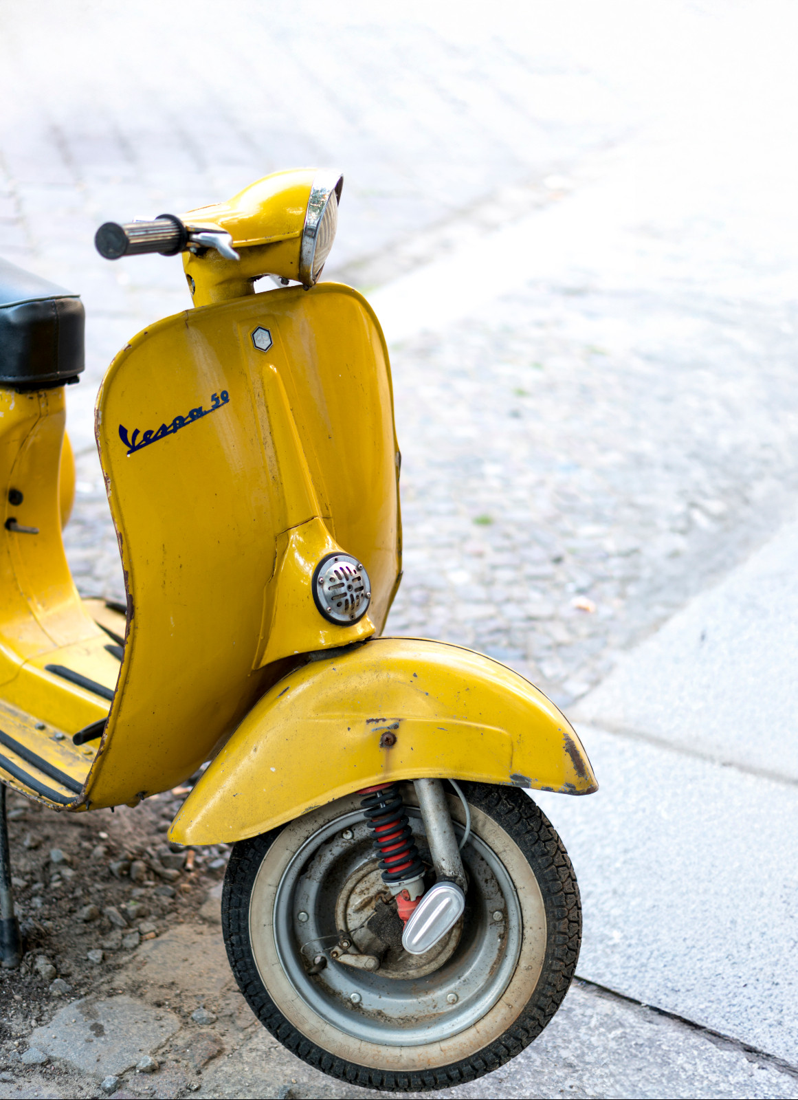 Berlin, Germany - September 26, 2016: yellow Italian vespa scooter. Vespa is an Italian brand of scooter manufactured by Piaggio of Pontedera. The name means wasp in Italian
