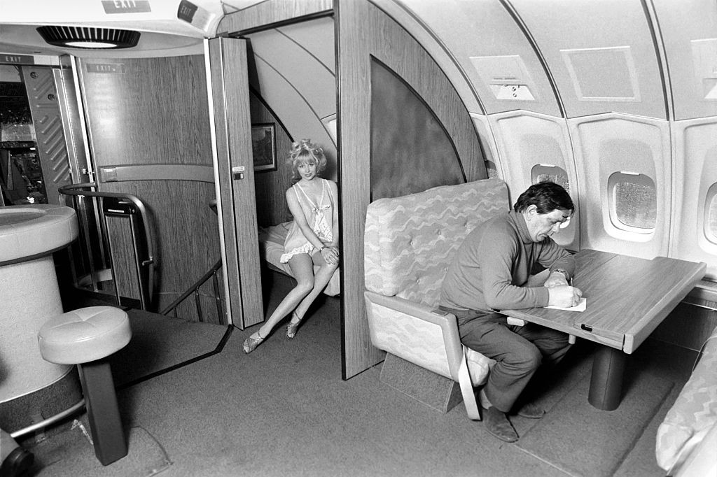 First class travel on a Boeing 747 in the 1970s meant access to its signature lounge, which could be reached by climbing a spiral staircase from the main passenger cabin. The lounge on Singapore Airlines featured sleeping compartments and a full-service cocktail bar (Photo by Fox Photos/Getty Images)