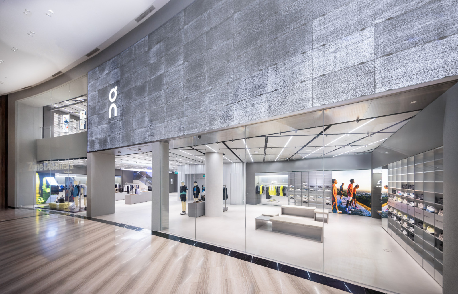 The two-storey On store features lighting fixtures which echo the reflective surfaces of the Singapore skyline and river