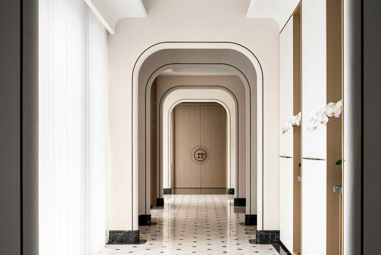 Repetitive arches unfold along the entrance, inspired by traditional arched vault design