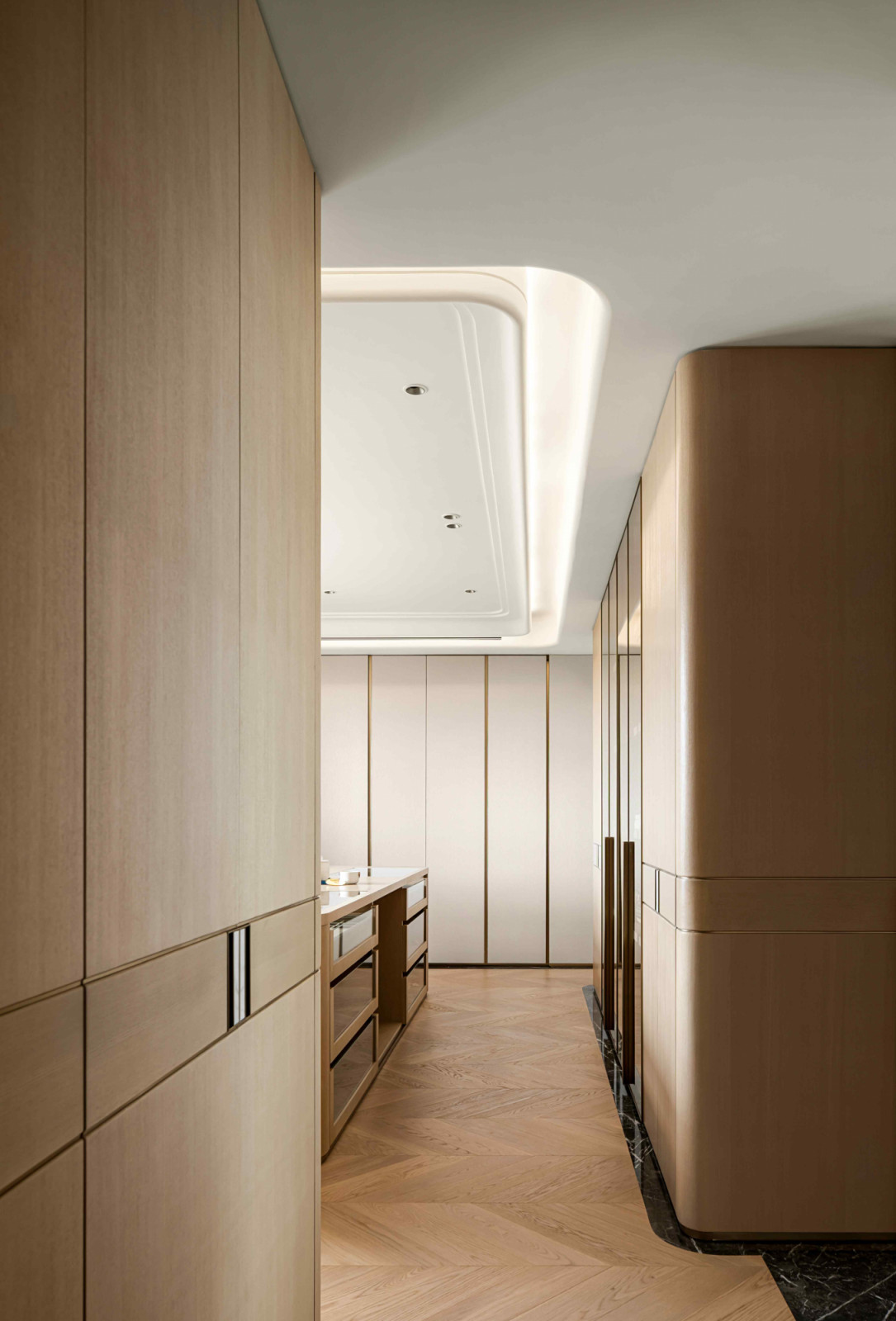 Wood materials provide warmth in the walk-in wardrobe