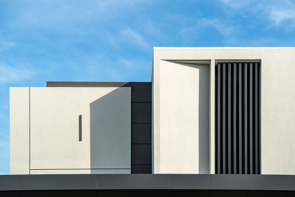 Detail of the villa’s upper level facade showing the clean geometric forms and material composition that emerged from designing the house from scratch