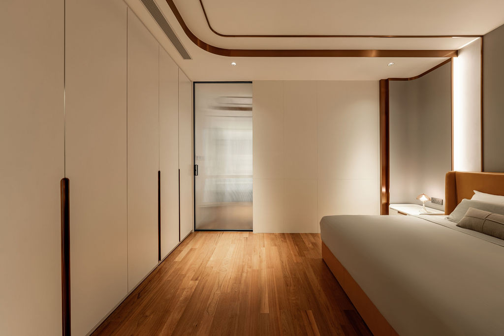 A bedroom showing the timber flooring on the upper level that, while warmer in tone, proves more difficult to maintain than the stone flooring Tiu would now prefer throughout