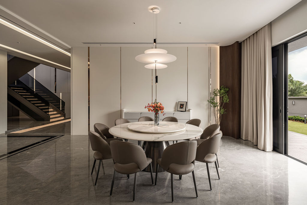 The dining area exemplifies the successful open-concept living and dining layout, with stone flooring providing a "solid and luxurious” feel underfoot that influenced Tiu’s material preferences.