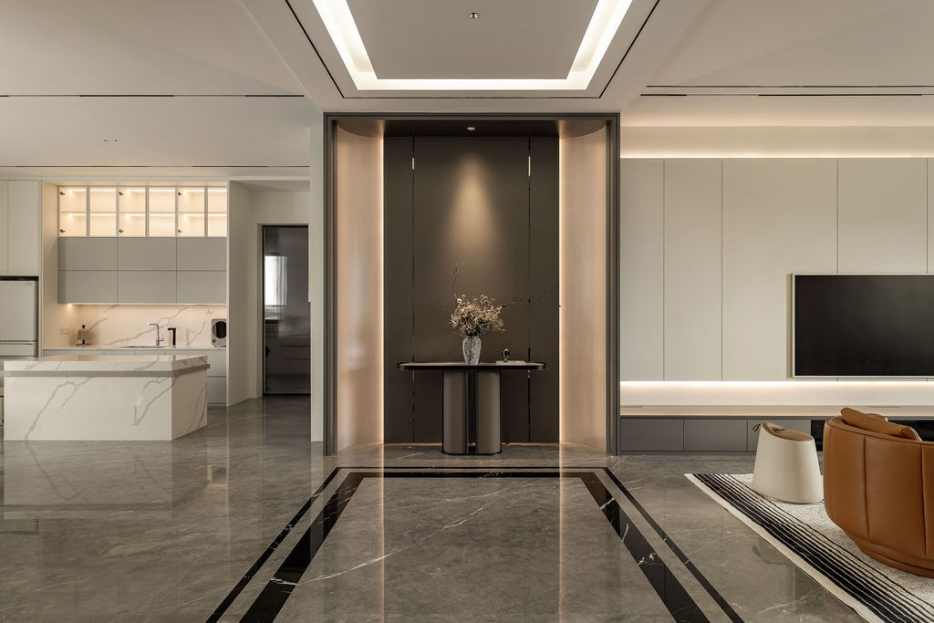 The open-concept living area showcases the stone flooring that Tiu wishes he had extended to the upper level, with natural light guiding movement between the kitchen and living spaces