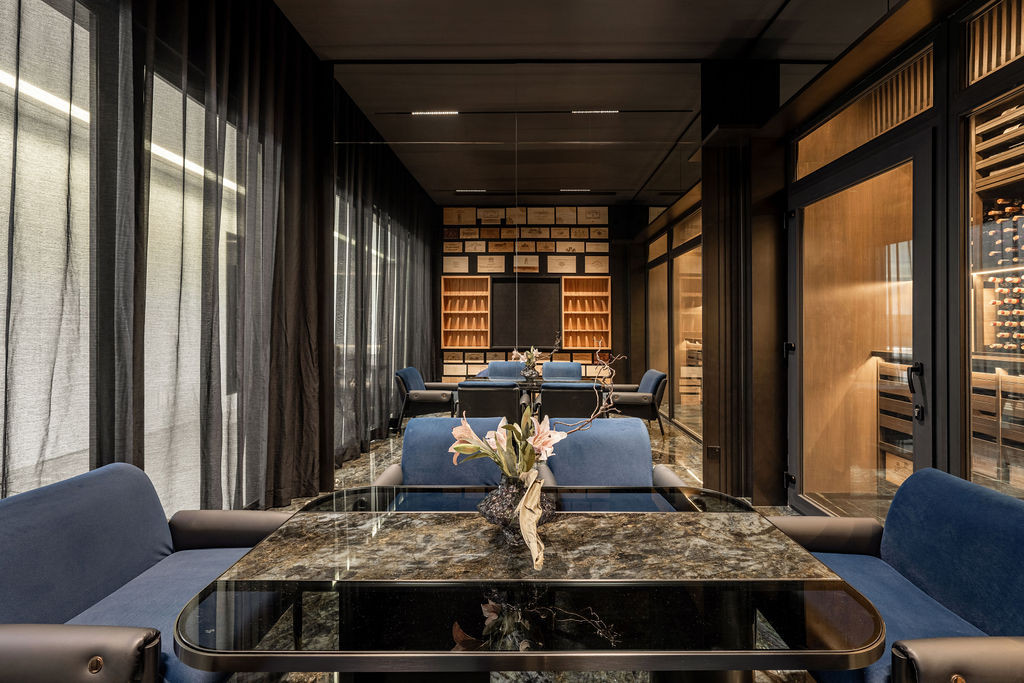 Interior view of the wine room showing the extensive storage and seating area where the family regularly hosts guests, demonstrating the space’s success beyond its original storage purpose