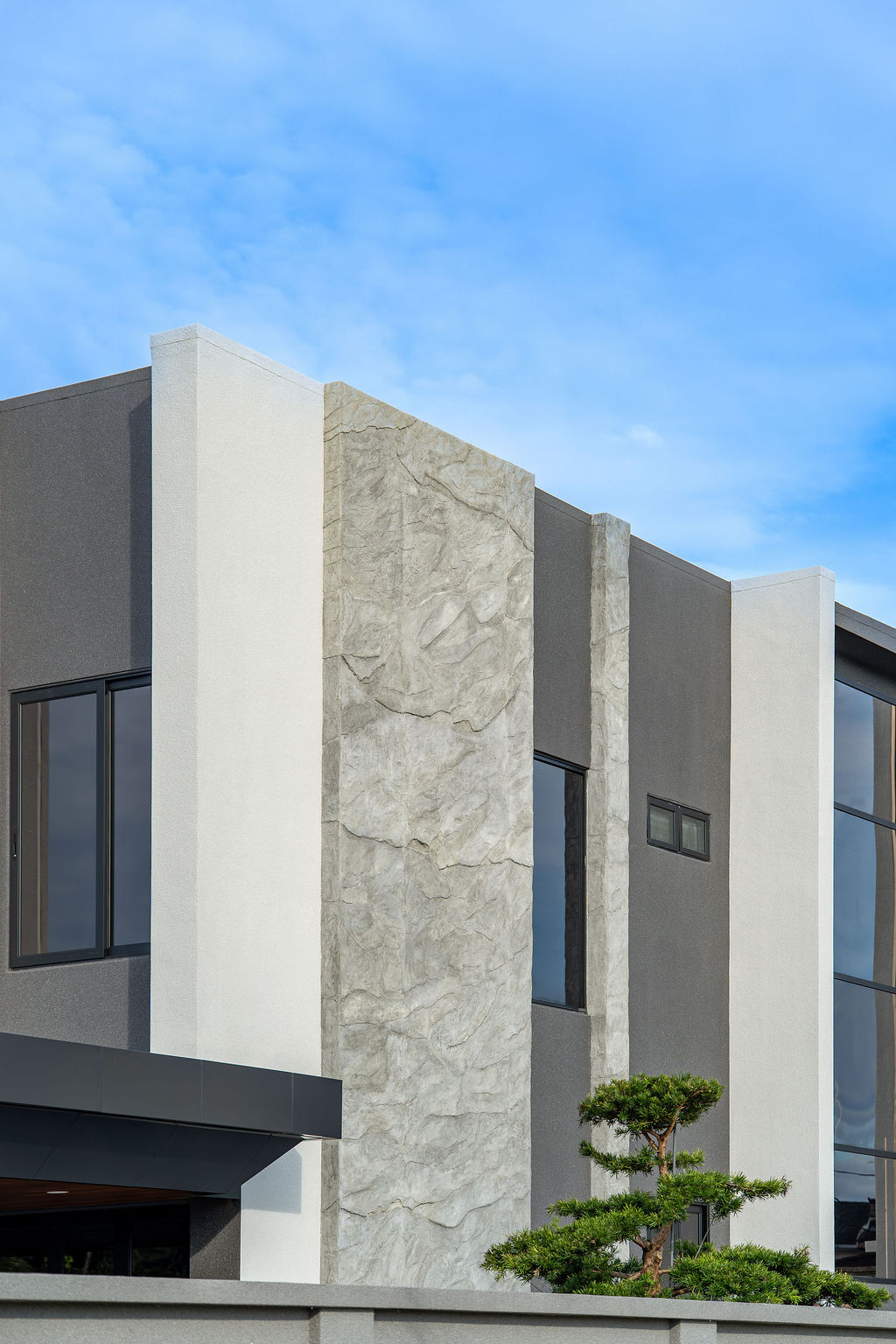 Detail of the facade showing the natural stone and matte finishes that reflect the client’s desire for “understated luxury” and materials selected to age gracefully over time