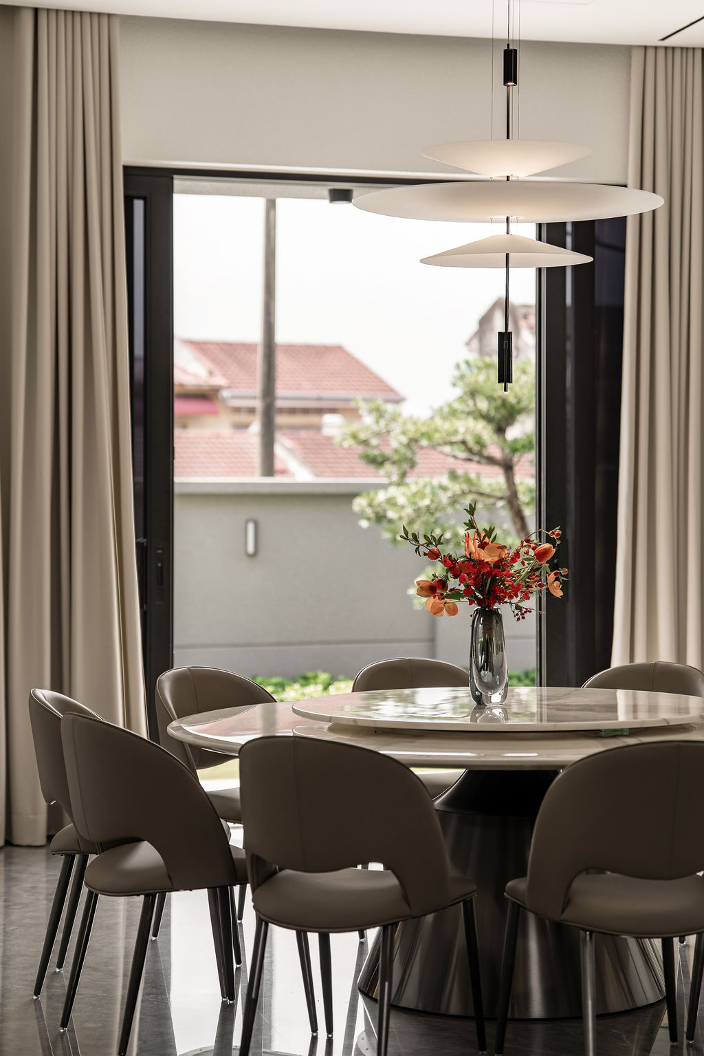 The dining area demonstrates the natural light that guides movement throughout the ground floor, with stone flooring that Tiu considers both substantial and easy to maintain