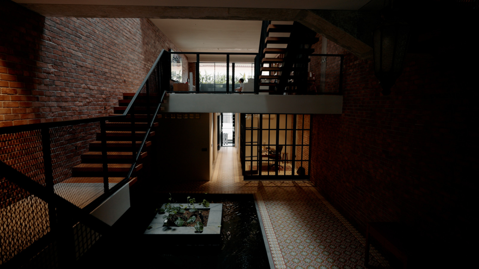 Natural light filters through the centre of the home, where a skylit courtyard and internal pond echo the breezy elegance of Southeast Asian shophouses