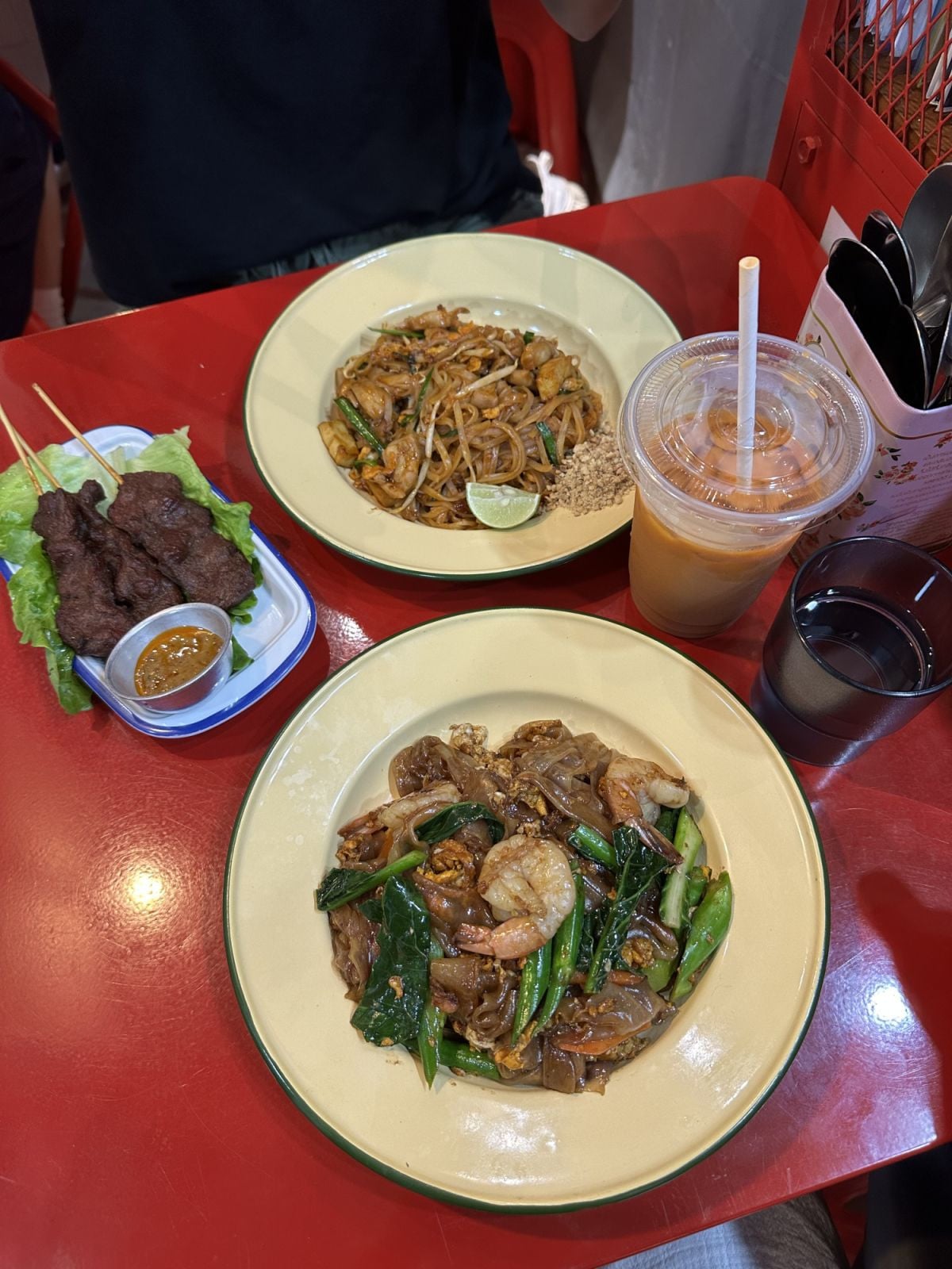 Pad see ew with prawns, chicken pad thai, beef skewers and Thai milk tea at Pin To