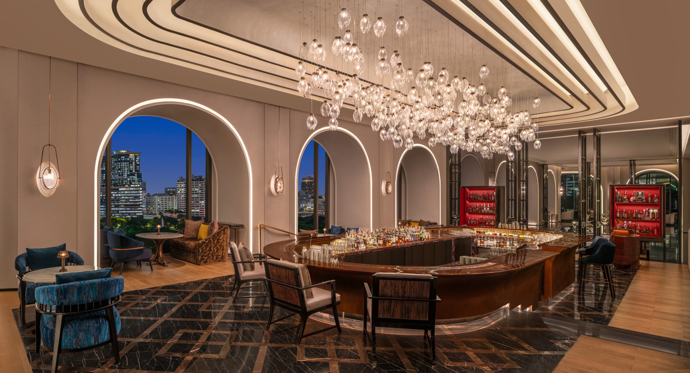 Caleō at The Ritz-Carlton, Bangkok at twilight, where dramatic lighting and skyline views frame a cocktail bar inspired by the world’s most storied social clubs