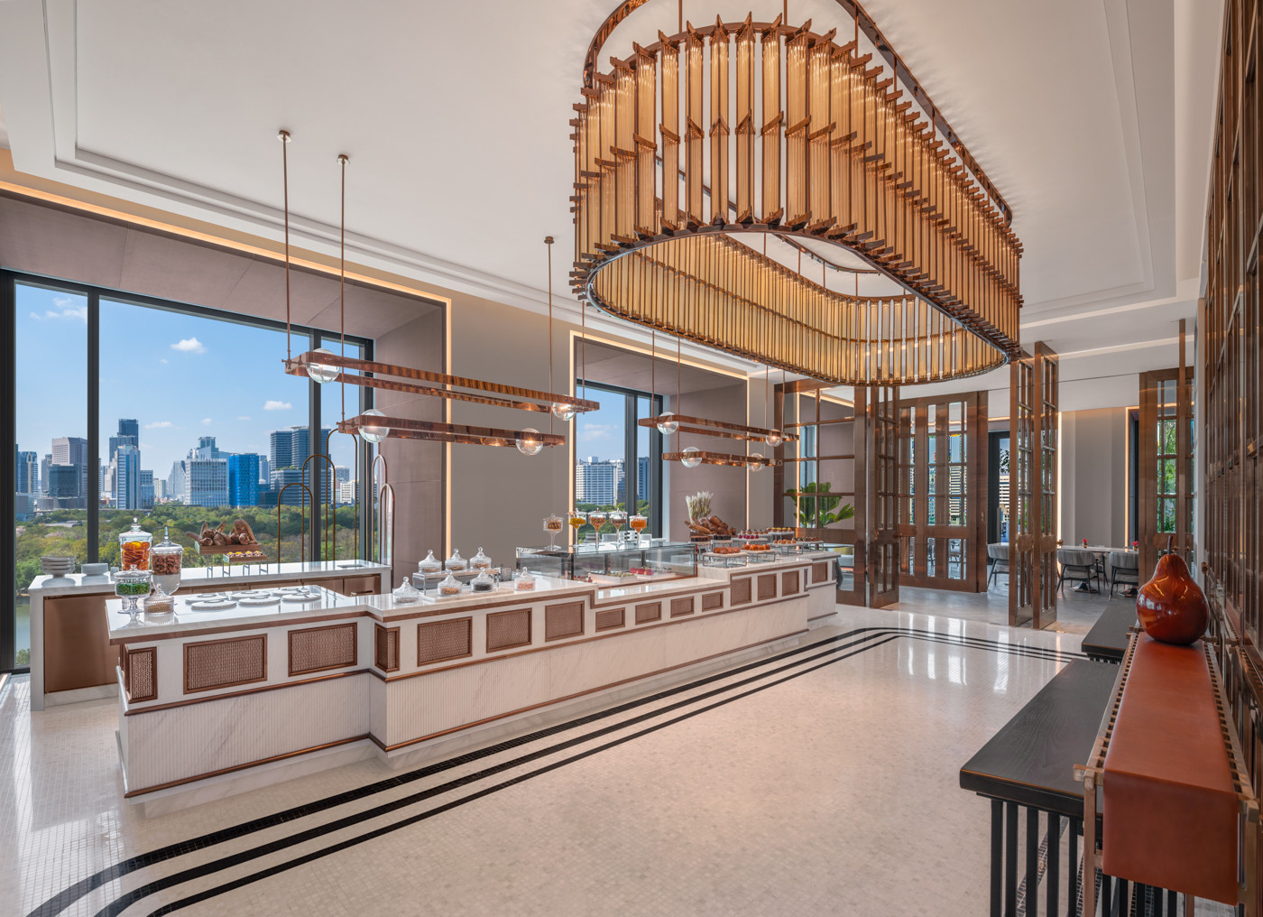 At Lily’s pastry station in The Ritz-Carlton, Bangkok, a selection of house-made treats includes a crescent-shaped croissant filled with Thai tea cream