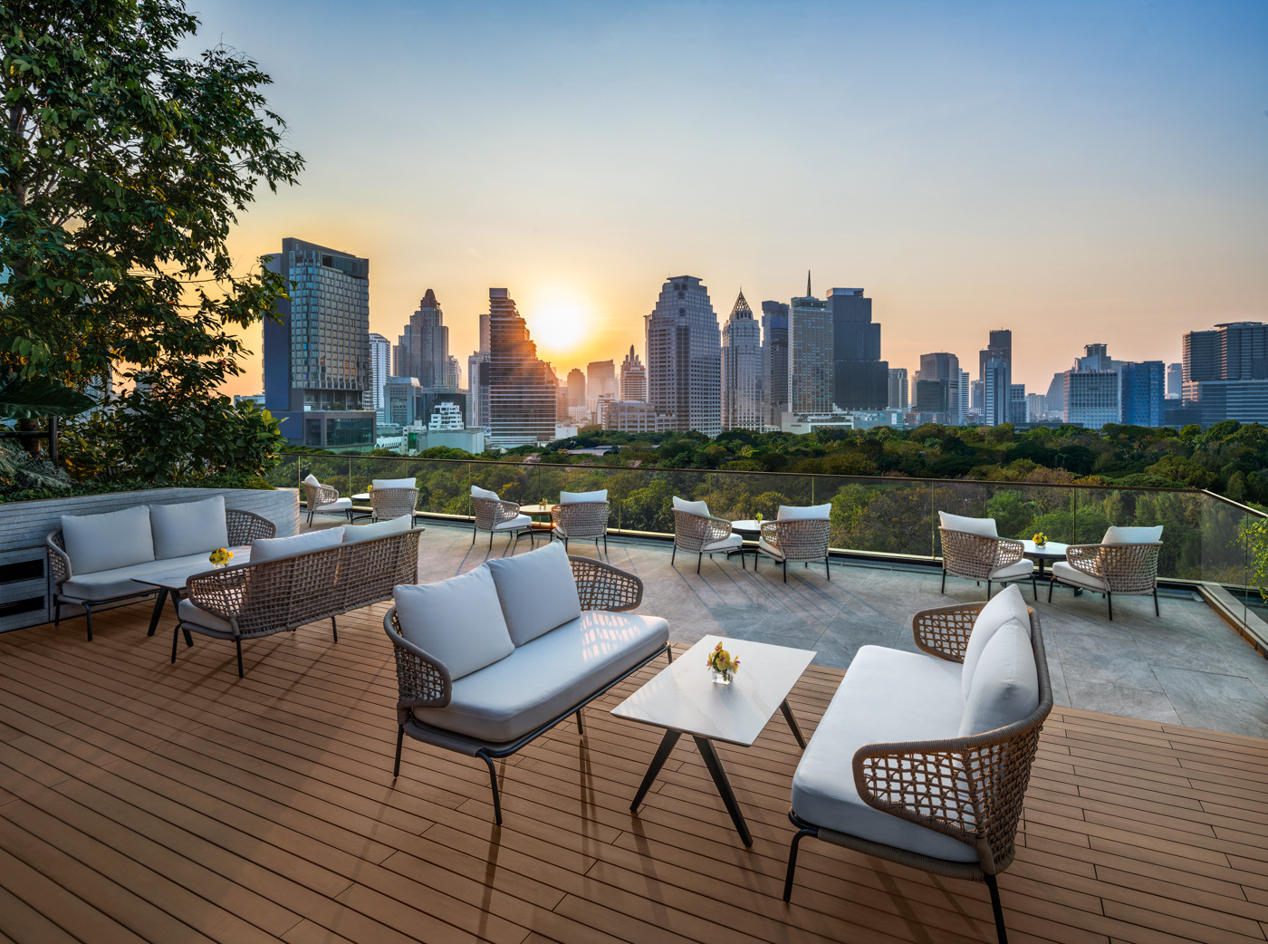 Sunset over the outdoor deck at The Ritz-Carlton, Bangkok, where daily rituals like the Klong Yao drum ceremony unfold against the changing city skyline