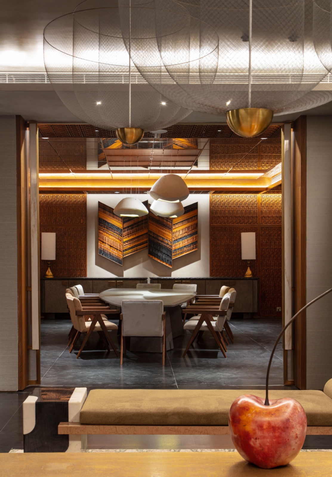 The basement dining room showcases Kashmiri pinjirakari latticework that transforms limited natural light into what designers Joya Nandurdikar and Amrita Guha describe as “a jewel-box ambience.”