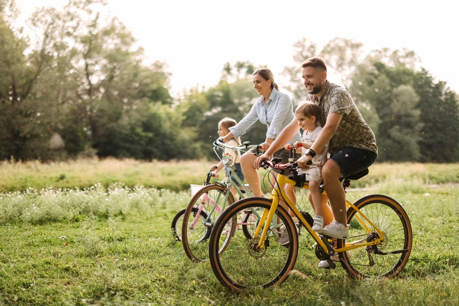 Family bike ride through the forest