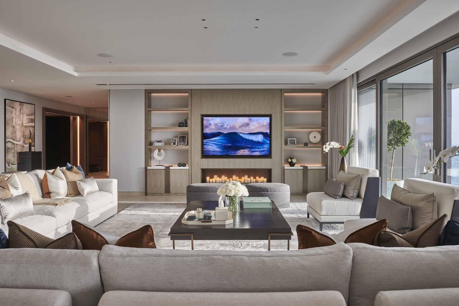 Natural light filters through the living room of this penthouse apartment on Palm Jumeirah Island, Dubai designed by Lumi Interiors
