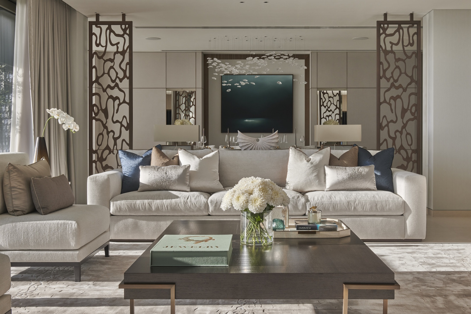 Natural light filters through the living room of this penthouse apartment on Palm Jumeirah Island, Dubai designed by Lumi Interiors
