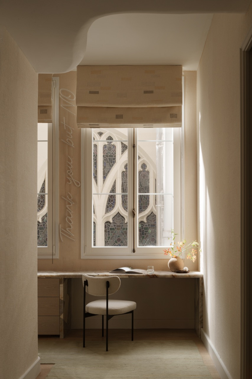 A curved window seat provides intimate seating where guests can sip wine with a friend