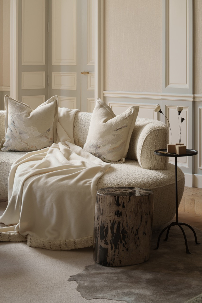 Boucle upholstery and curved seating demonstrate the “soft chenille, boucle, and alpaca wool” fabrics that Ashby describes as “wrapping you up like a blanket of dreams”