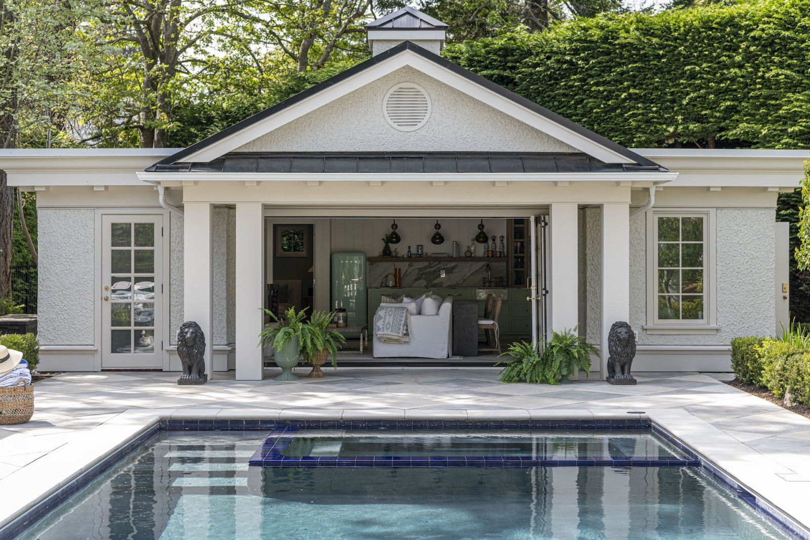 The pool house of a restored Victoria, British Columbia home, designed by Lauren Kyle McDavid for NHL player Tyson Barrie