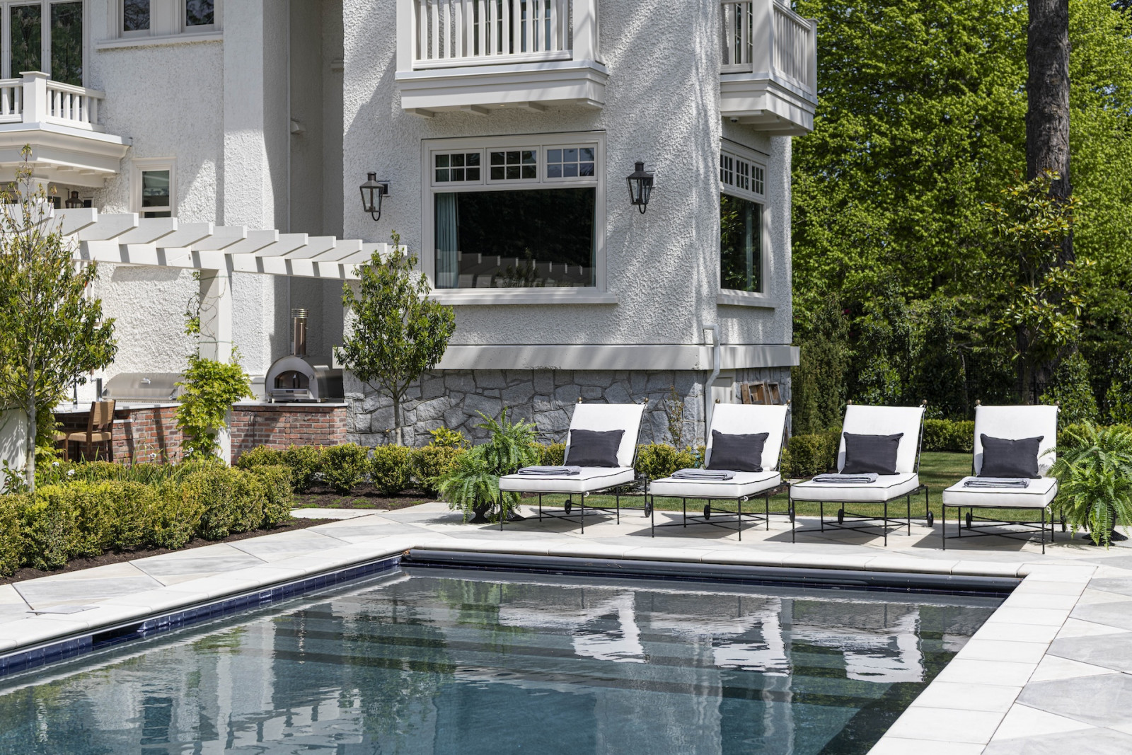 The back garden and pool area of a restored Victoria, British Columbia home, designed by Lauren Kyle McDavid for NHL player Tyson Barrie