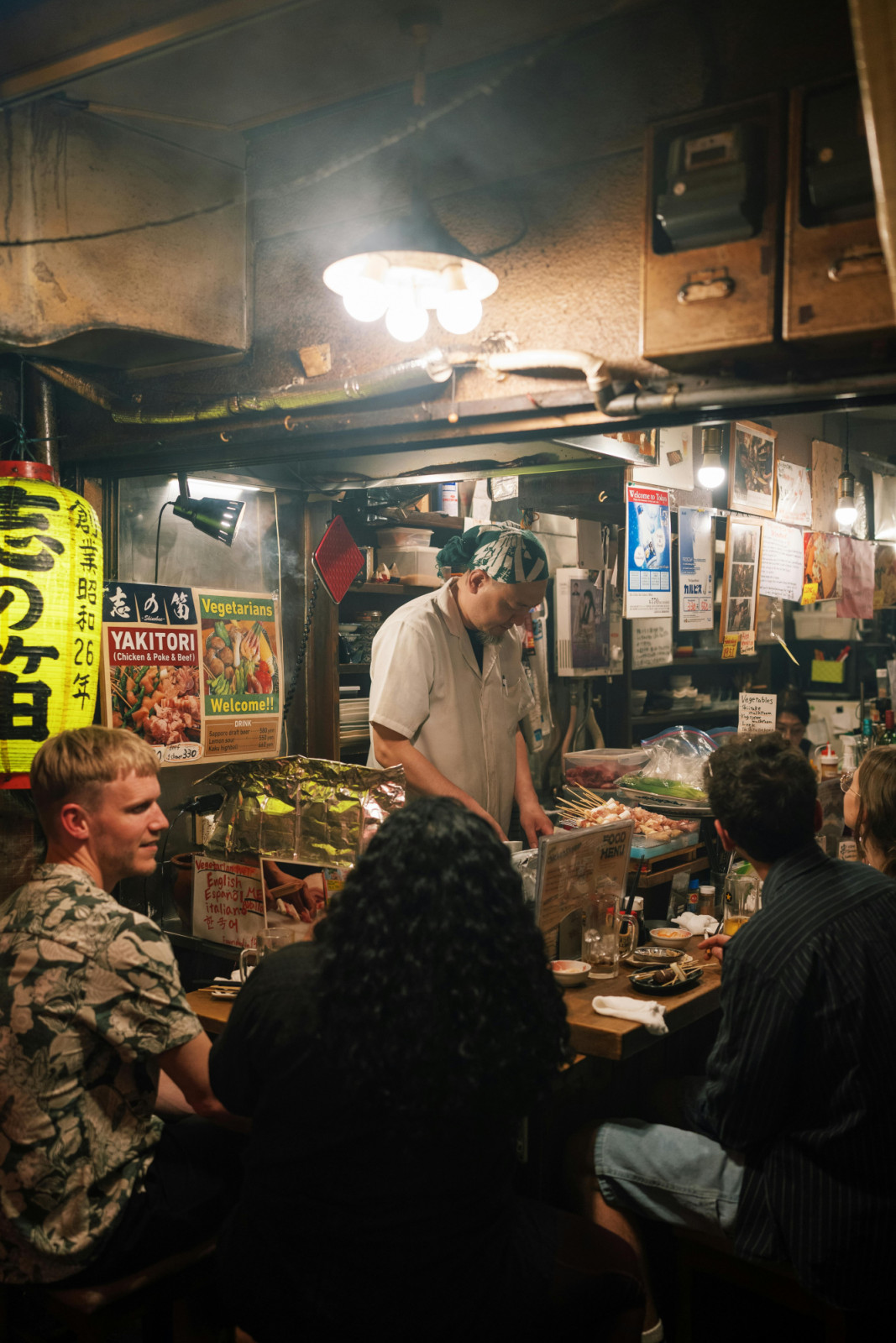 In izakaya culture, pouring drinks for others and sharing small plates embody the spirit of omotenashi.