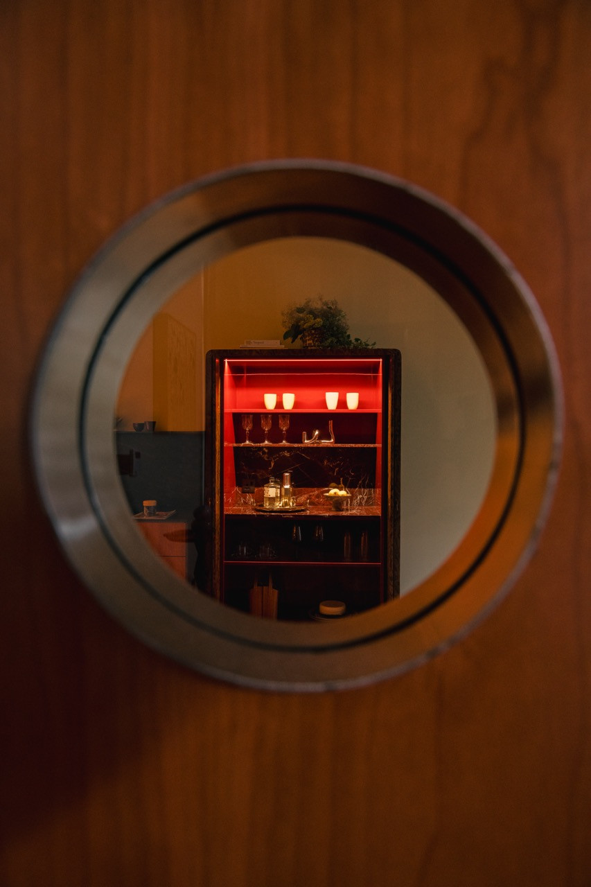 The cabinet’s interior reveals piano gloss surfaces and glassware, visible through the circular opening that frames this “very nice element" Gioh wanted to recreate from family memory