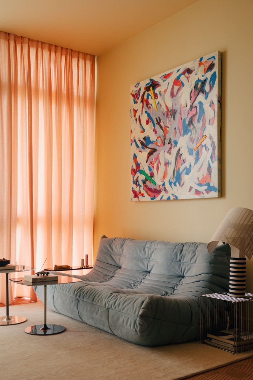 The iconic Ligne Roset Togo sofa anchors the living space, with the terracotta-toned Mutina tiles designed by Michael Anastassiades