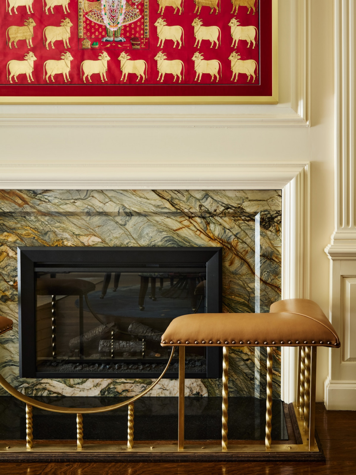The fireplace of the living room in a maximalist 1920s Georgian home in Boston that blends Mexican and Indian influences, designed by Vani Sayeed Studio