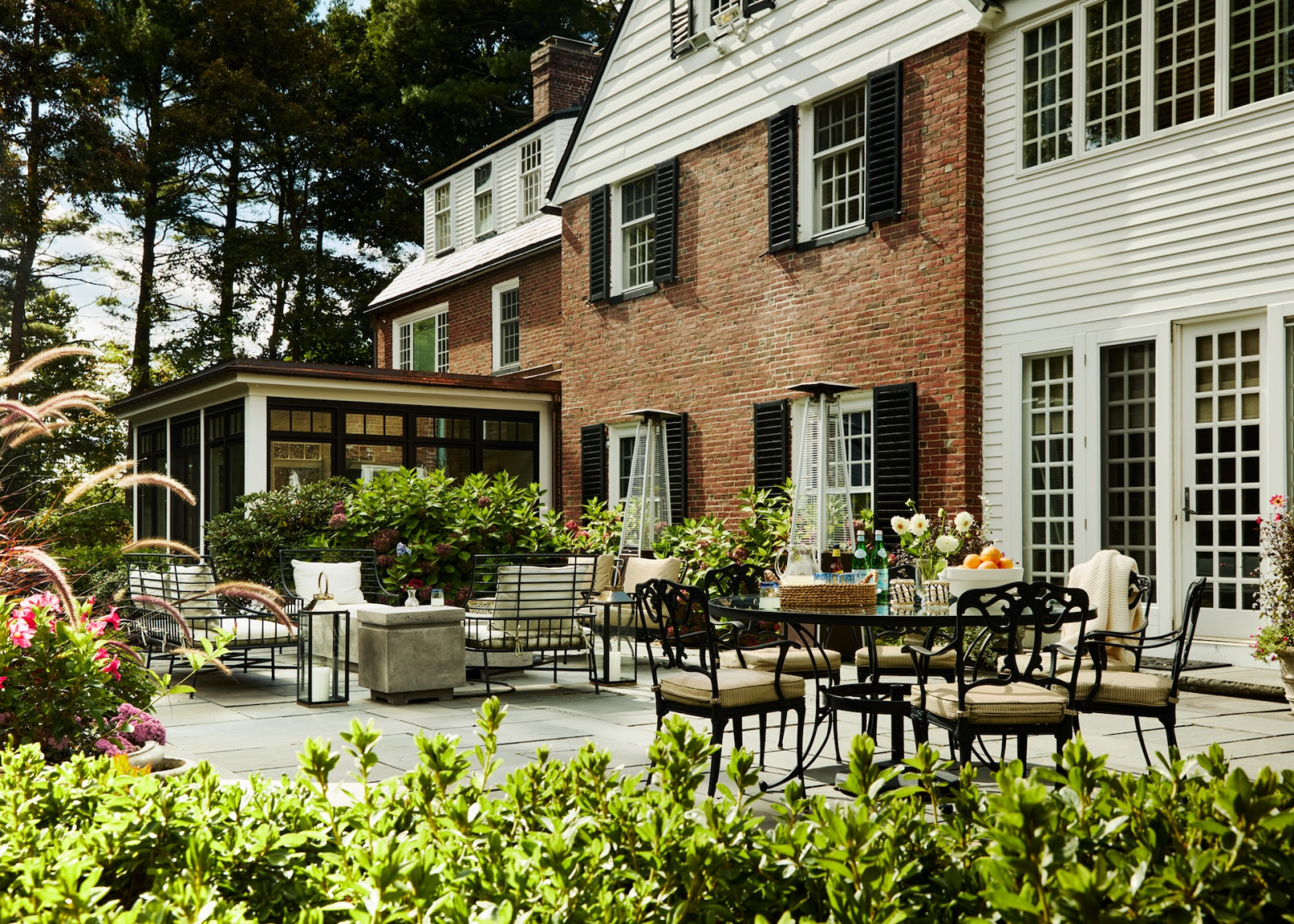 The backyard in a maximalist 1920s Georgian home in Boston that blends Mexican and Indian influences, designed by Vani Sayeed Studio