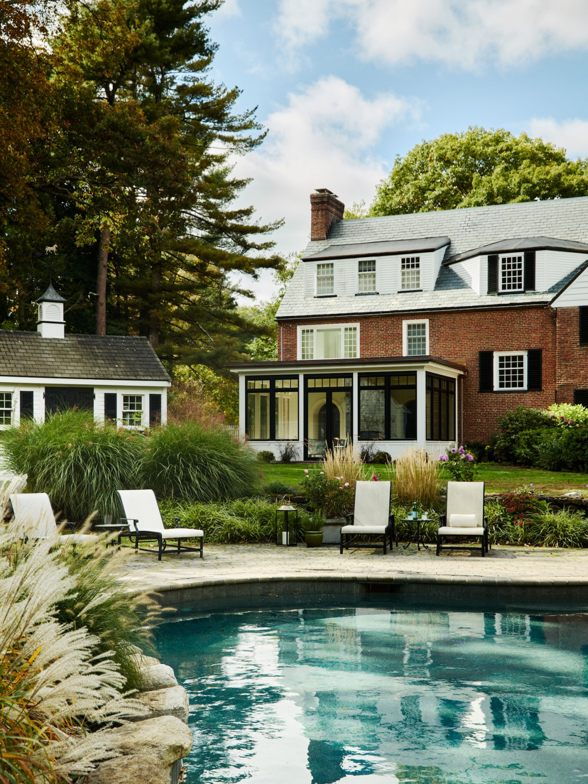 The pool area in a maximalist 1920s Georgian home in Boston that blends Mexican and Indian influences, designed by Vani Sayeed Studio