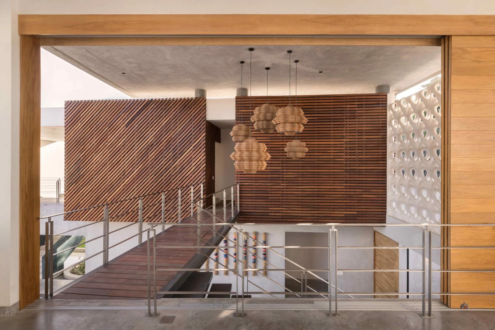 Wall-less but covered corridors and untreated timber screens that weather naturally overtime (Photo: Marcos Garcia)