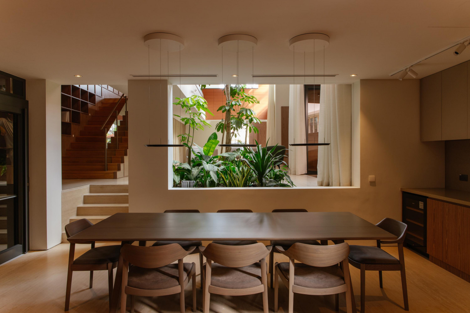 The view from the intimate dining room, which is clad in warm timber tones