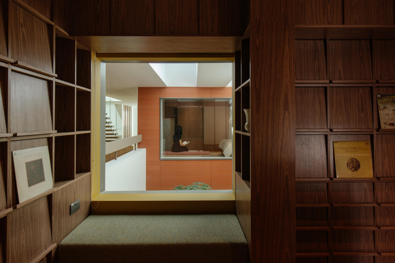 This cushioned bay window in the vinyl library makes for a cool and quiet spot on which to perch