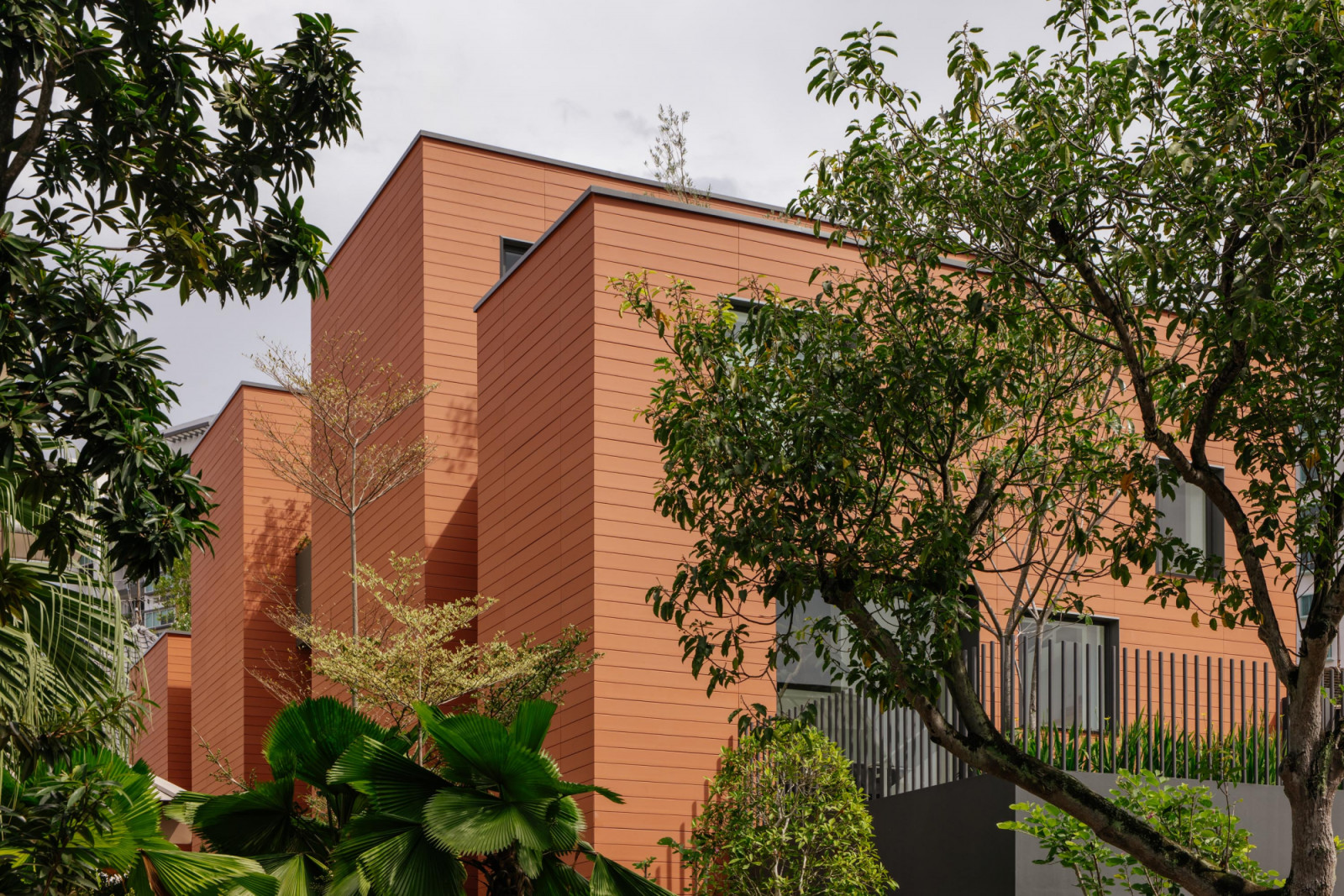 An exterior view reveals the semi-detached home’s four distinct volumes—inside, the interstitial spaces between them are as integral to the design as the rooms themselves