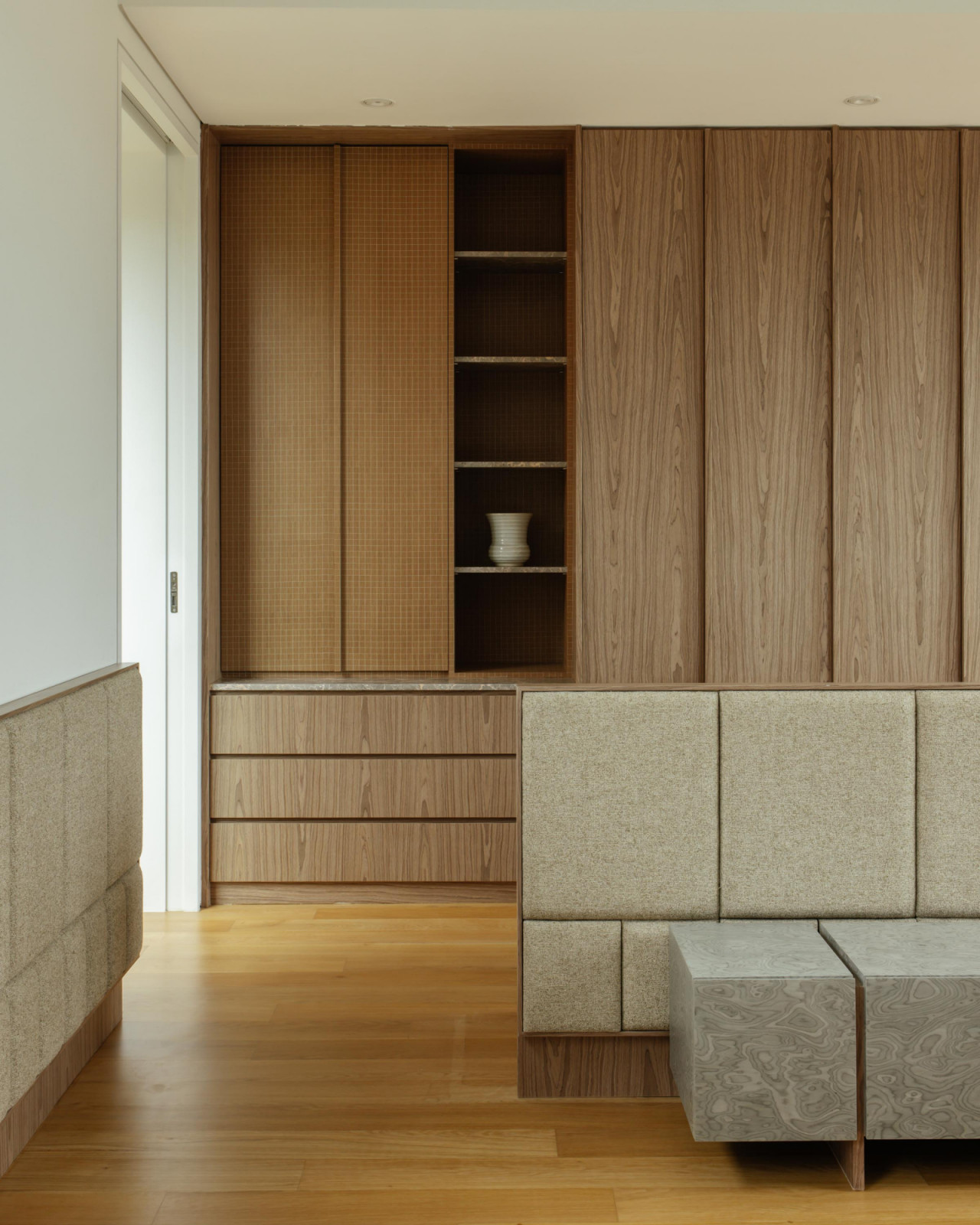 Timber finishes with subtle textures build a layered material palette that harmonises with the semi-detached home’s nature-centric ethos