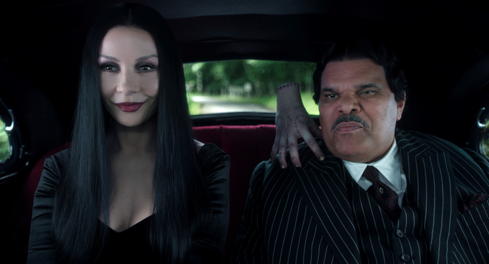 Wednesday. (L to R) Catherine Zeta-Jones as Morticia Addams, Thing, Luis Guzmán as Gomez Addams in episode 201 of Wednesday. Cr. Courtesy of Netflix © 2025